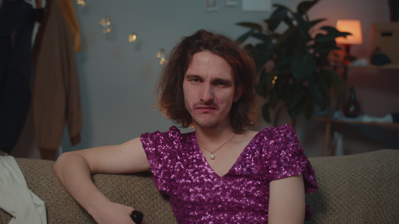 Man in dress sitting on couch