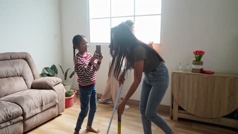 family cleaning day: mom and daughters teamwork