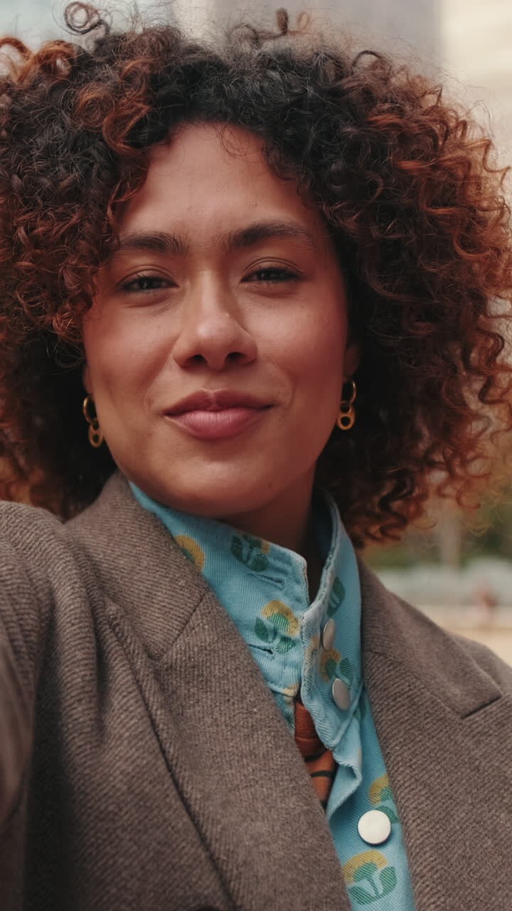 Happy Businesswoman Waving to Camera in City