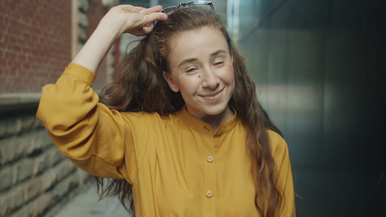 Smiling Woman in Yellow Shirt with Sunglasses