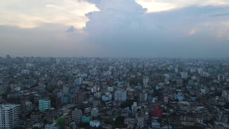 aerial: metropolitan urban city, densely constructed buildings - establishing top drone descending shot