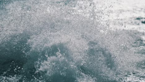 splashing water backwash from motorboat sailing over lake during sunny day