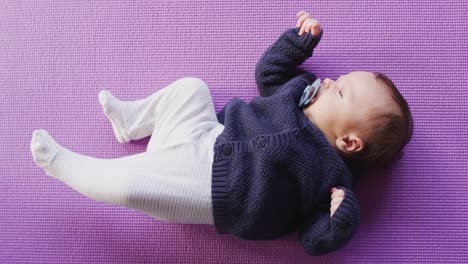 Video-of-caucasian-newborn-baby-sleeping-on-violet-blanket