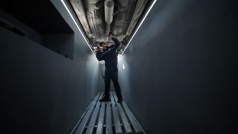 mechanic working on car undercarriage