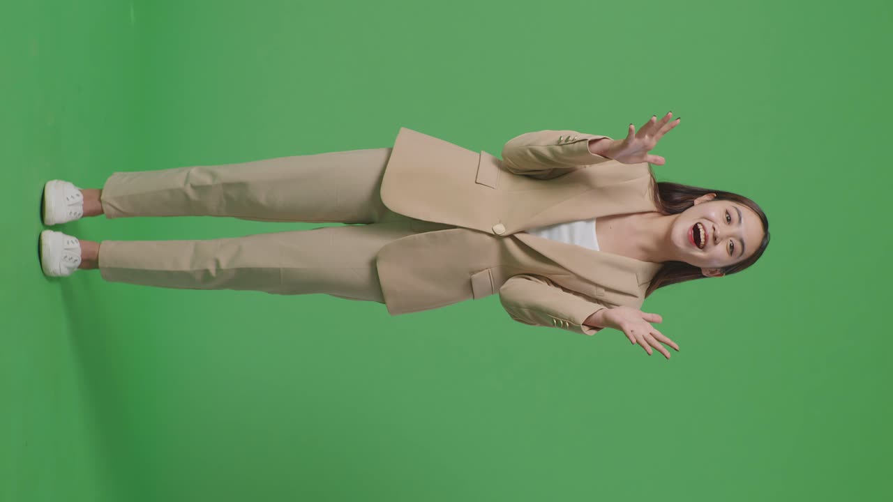 Full Body Of Asian Business Woman Showing Gesture Hands Palm Saying Wow And Smiling In The Green Screen Studio
