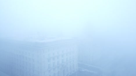 Thick-dense-ghostly-fog-cover-across-Liverpool-city-aerial-view-of-surreal-downtown-waterfront-dolly-right-shot