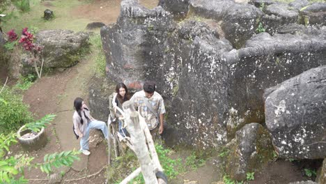 young asian friends walking on forest footpath in nature