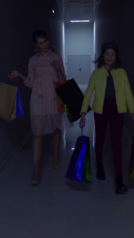 two women and a girl shopping in a mall