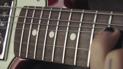 Hands-with-a-shabby-black-nail-polish-playing-the-guitar