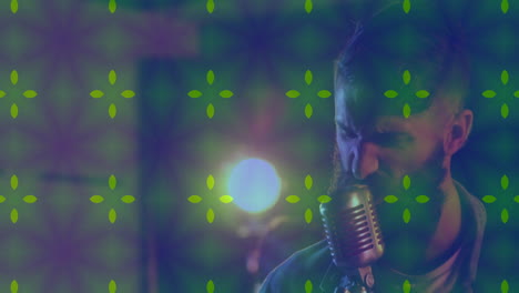 male vocalist performing into microphone in music studio with colored lights and starburst overlays