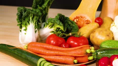 assorted vegetables arranged on a wooden surface