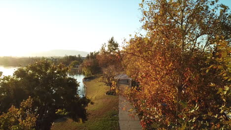 sunrise over fall trees and lake waters in southern california