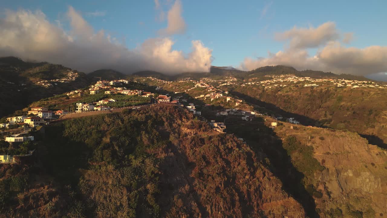 Aerial view of the beautiful city on the cliffs, under the clouds Calheta, Madeira, Portugal.