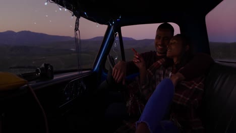 young couple on a road trip in their pick-up truck