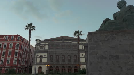 panoramic of the benito perez galdos theater and in the foreground the statue honoring the writer