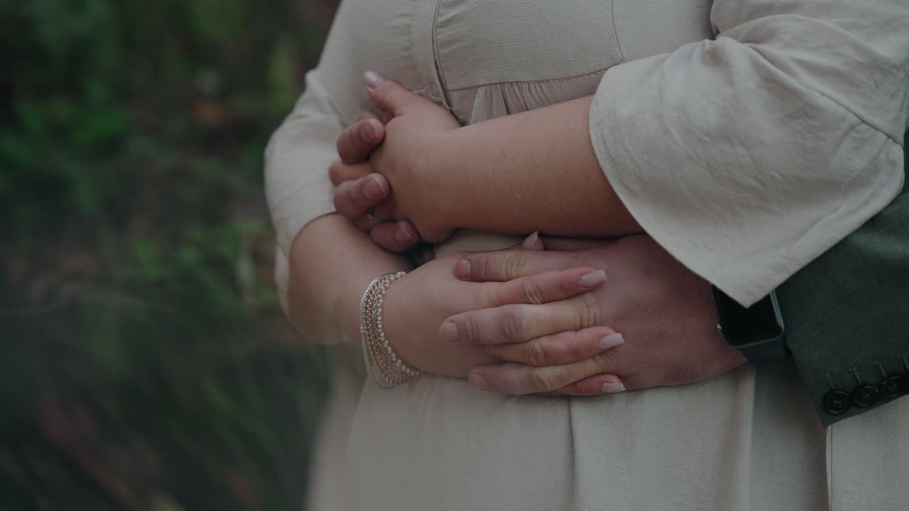 Close up of a couple embracing, their hands gently intertwined in a loving moment
