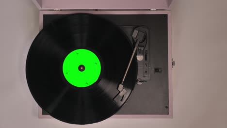 vintage vinyl gramophone player playing the record. green screen at title