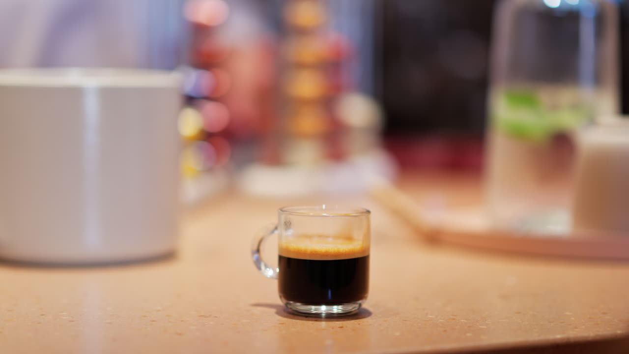 Close up of a cup of coffee on a table at a restaurant with a blurred background