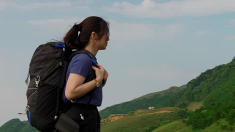 beautiful-solo-female-traveller-backpacker-walking-alone-in-mountains-trekking-pack-slow-motion