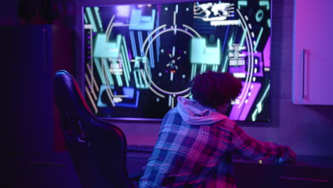 a young biracial man talks on his gaming headset, purple background, copy space