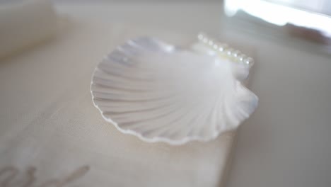 baptismal shell and pearls on cloth