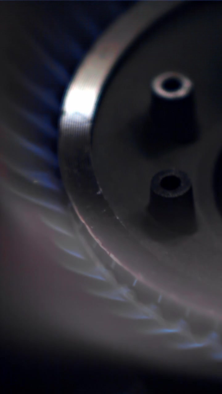 Close-up of Gas Stove Burner Igniting and Extinguishing Blue Flame