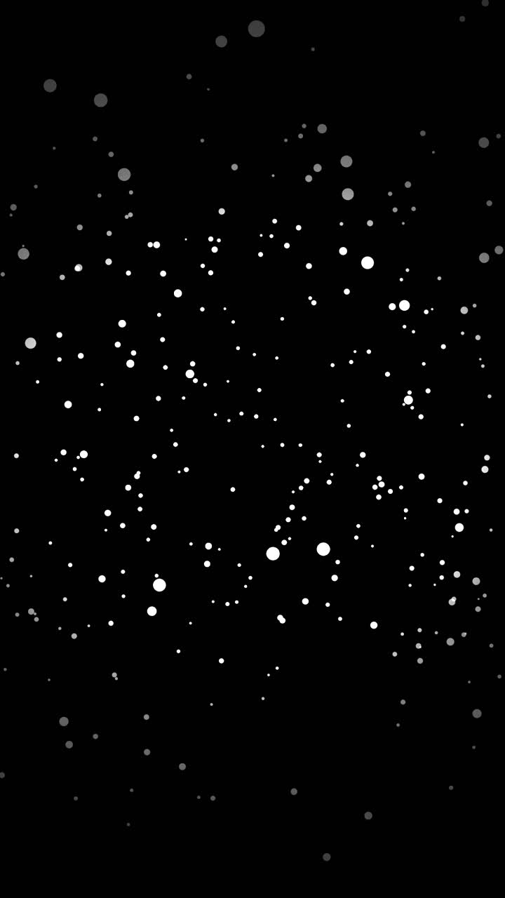 White aerated particles bounce and float in chaotic motion on vertical black background