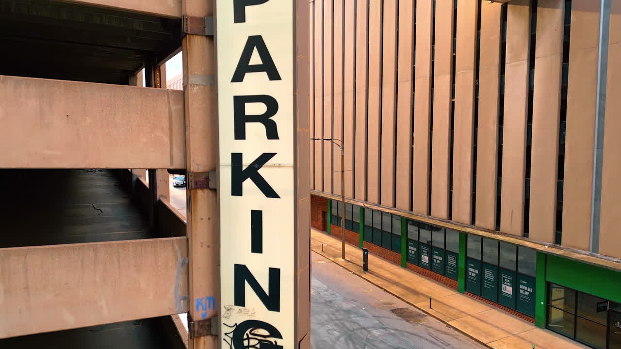 Saint Louis USA, 14 August 2025: Parking sign hanging on the façade of the building. Close up. Drone footage rising near the building