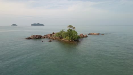 aerial dolly orbit small rocky tropical island in gulf of thailand