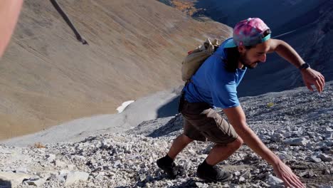 Hiker-ascending-scrambling-climbing-close-up-pan-Kananaskis-Alberta-Canada