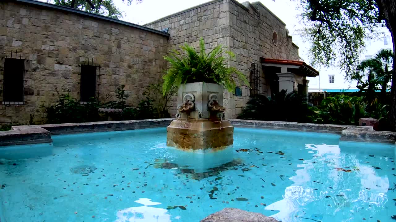 Fountains around the courtyard add the sound of running water to the peaceful gardens of The Alamo complex.  4K30fps