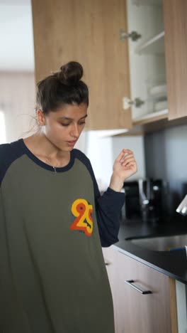 woman in kitchen performing chores