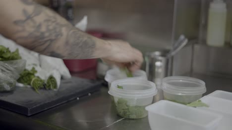 chef preparing fresh herbs in restaurant kitchen