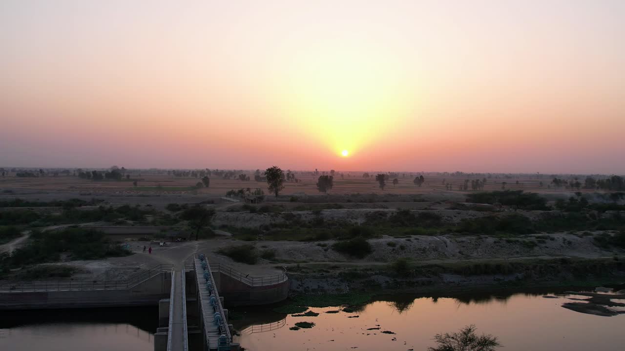 Sunset casting golden hues over Sutlej River and agricultural lands in Punjab. Punjab