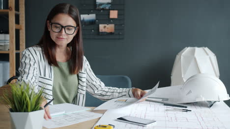 woman architect reviewing plans in an office