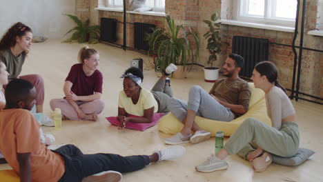 group of dancers resting and chatting in studio