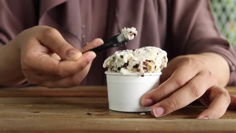 una mujer disfrutando de un helado de chocolate