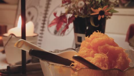 Cinematic-shot-of-indoor-fall-scene-with-a-bowl-of-pumpkin-guts,-thanksgiving-concept