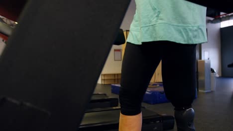 senior woman using virtual reality headset on treadmill 4k