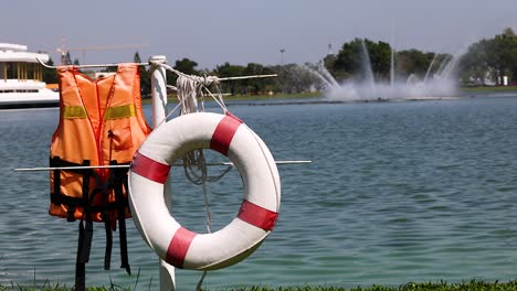 life jackets and ring by a serene lake