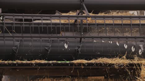 Slow-motion-shot-of-harvest-combine-harvesting-wheat-in-the-field-at-daytime