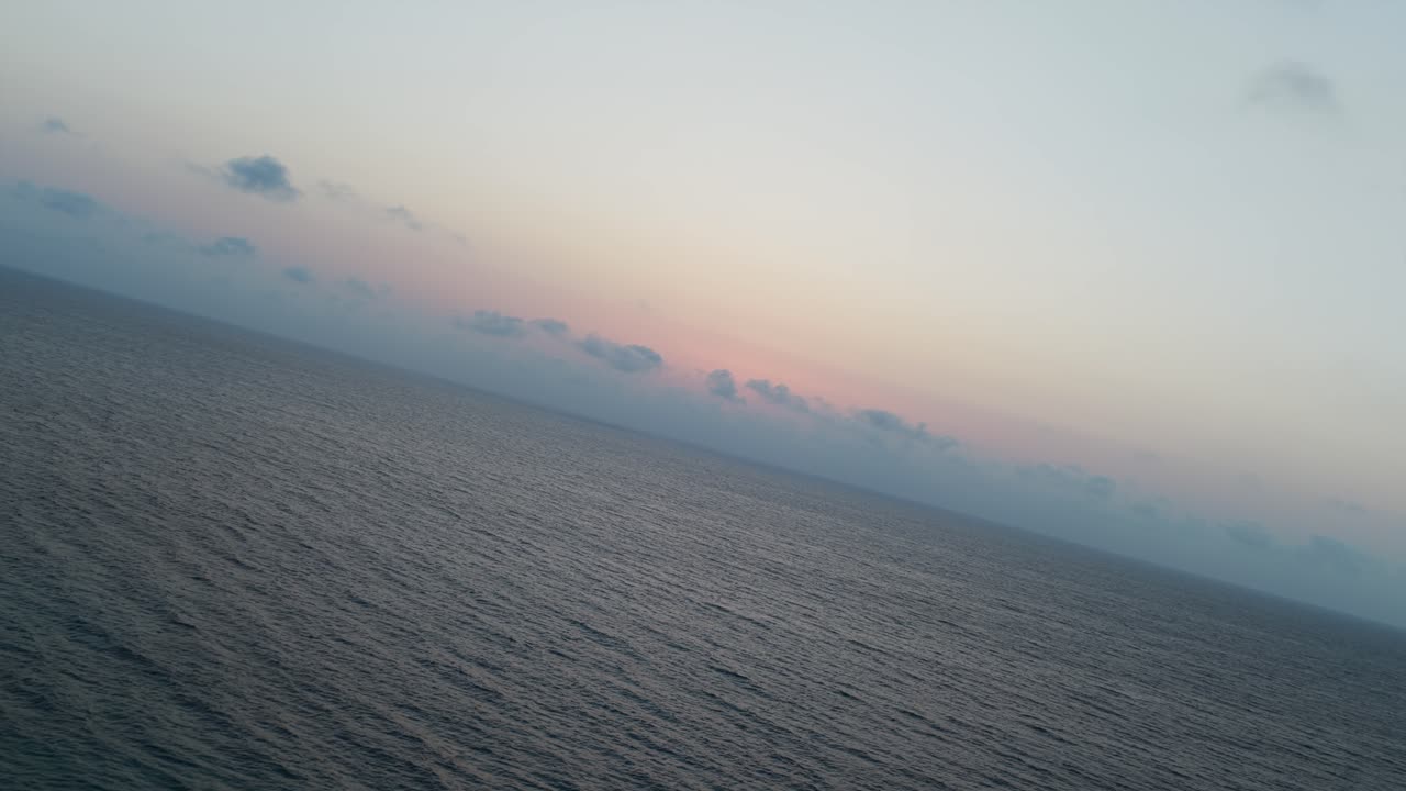 Aerial view of Adriatic Sea at sunrise. Colorful twilight sky over calm water. For nature or travel content, Torre Sant'Andrea, Puglia, Italy