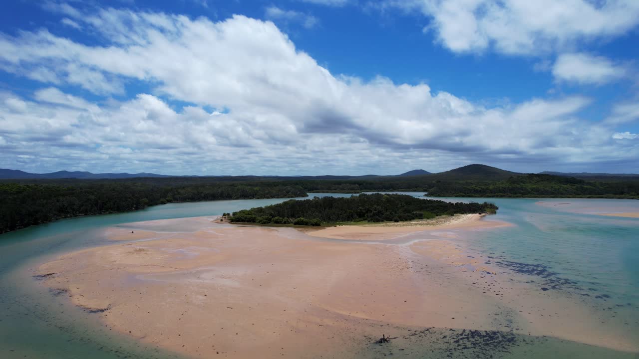 Red rock beach and corindi river under blue skies in new south wales, aerial view