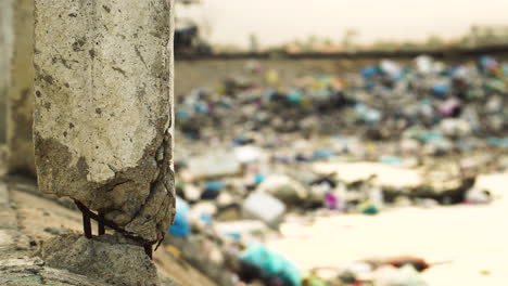 A-Built-Concrete-Post-With-Blurry-View-Of-Son-Hai-Rubbish-In-Vietnam