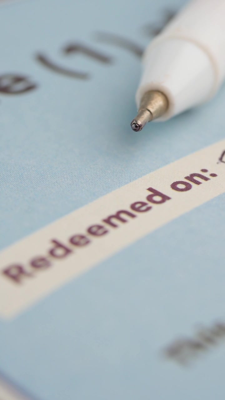 Close-up of a Pen Writing a Date on a Document