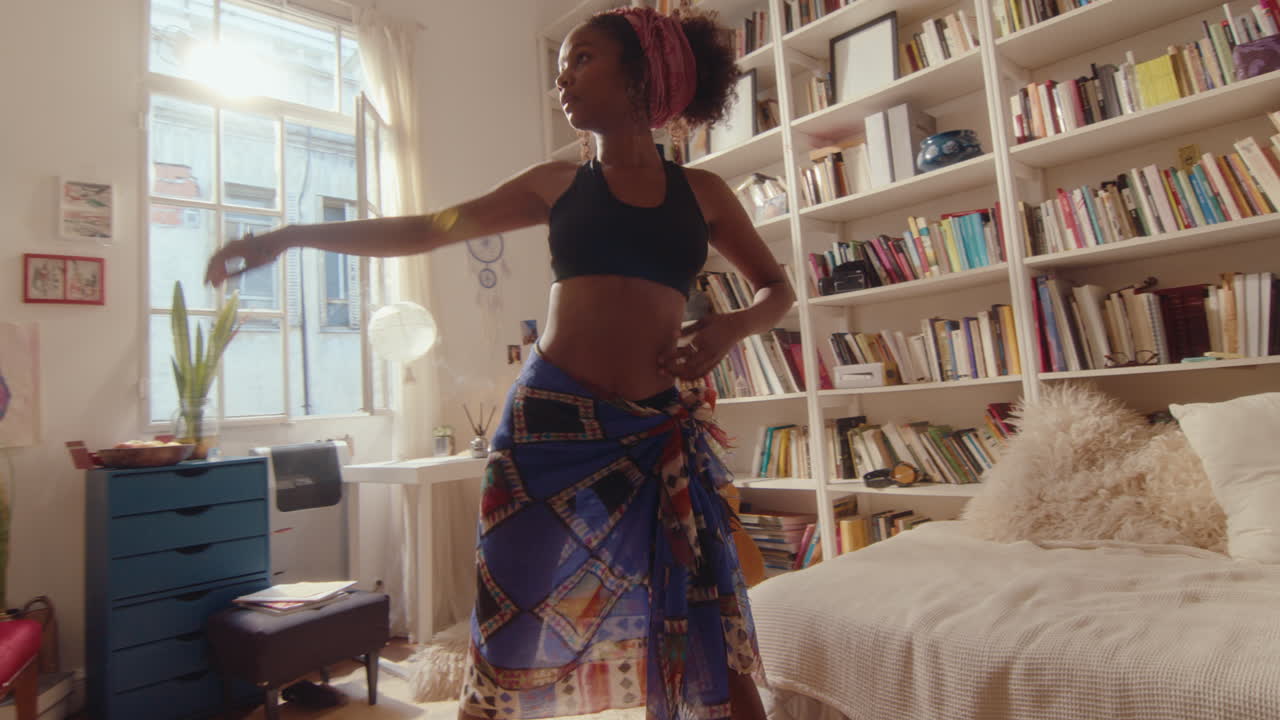 Inspired Black Woman Dancing in Sunlit Living Room