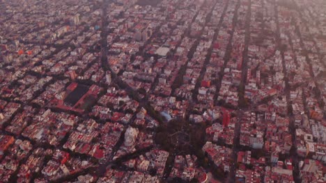 wide drone shots of mexico city at sunset, featuring interesting streets architecture as seen from above