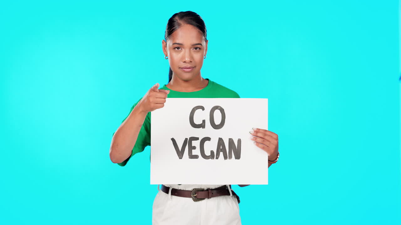 Go vegan sign, protest and woman face pointing