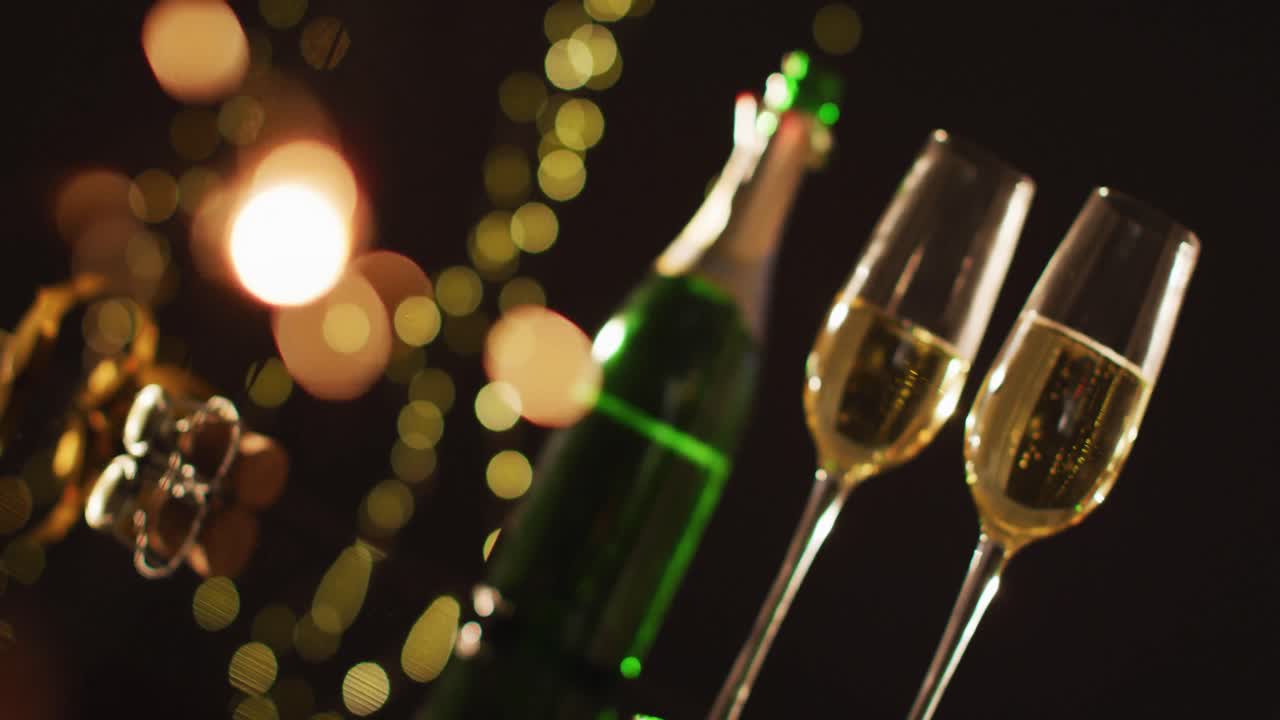 Champagne glasses and decorations on black background at new year's eve