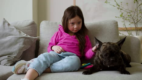 girl petting dog at home